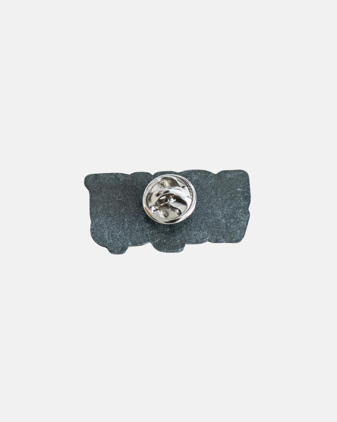 The Long Way Shops Long Way Up Pin Badge is a rectangular, irregularly-shaped dark pin with a silver butterfly clasp on the back, shown against a plain white background.