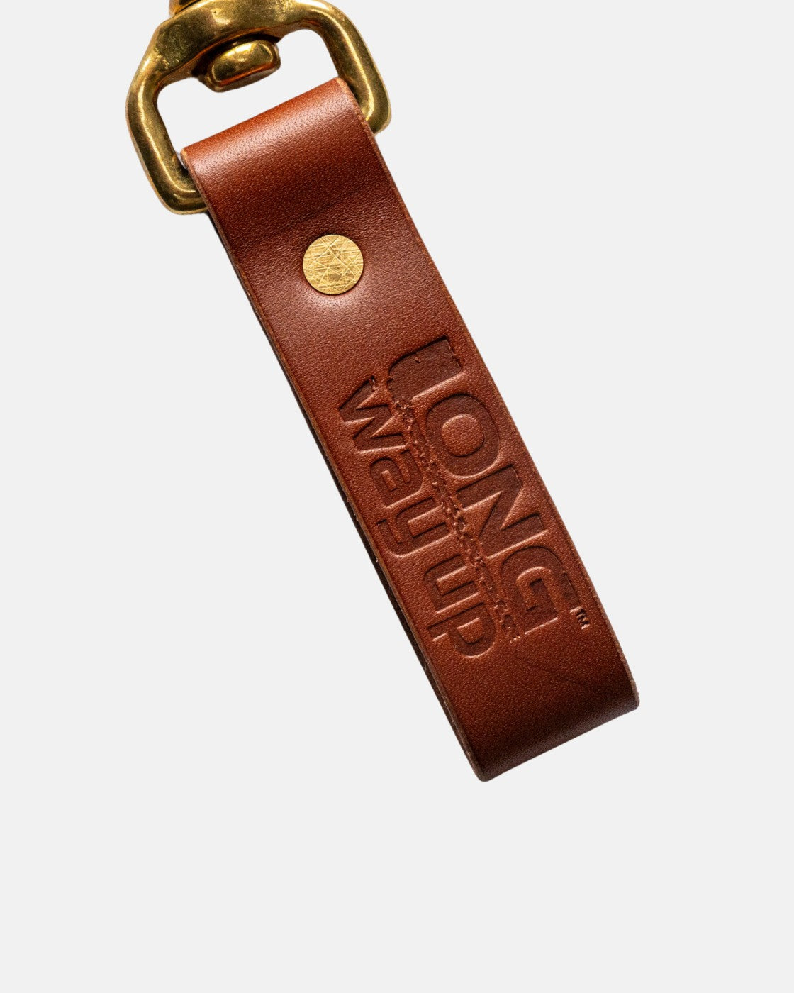 The Long Way Up Lanyard by Long Way Shop is a brown leather keychain with a brass clasp, embossed with LONG Way UP.