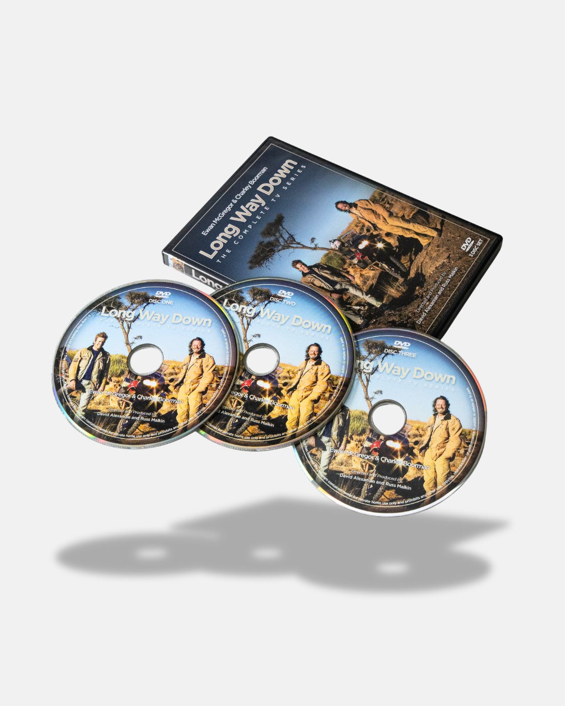 The Long Way Down DVD by Long Way Shop includes three discs and a case, featuring two men in motorcycle gear next to bikes in a rural landscape under a blue sky.