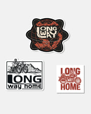 The Long Way Shop Sticker Set (set of 3) features a stylized globe with LONG WAY, two riders on motorcycles with LONG way home, and a motorcycle with bold red LONG WAY HOME.
